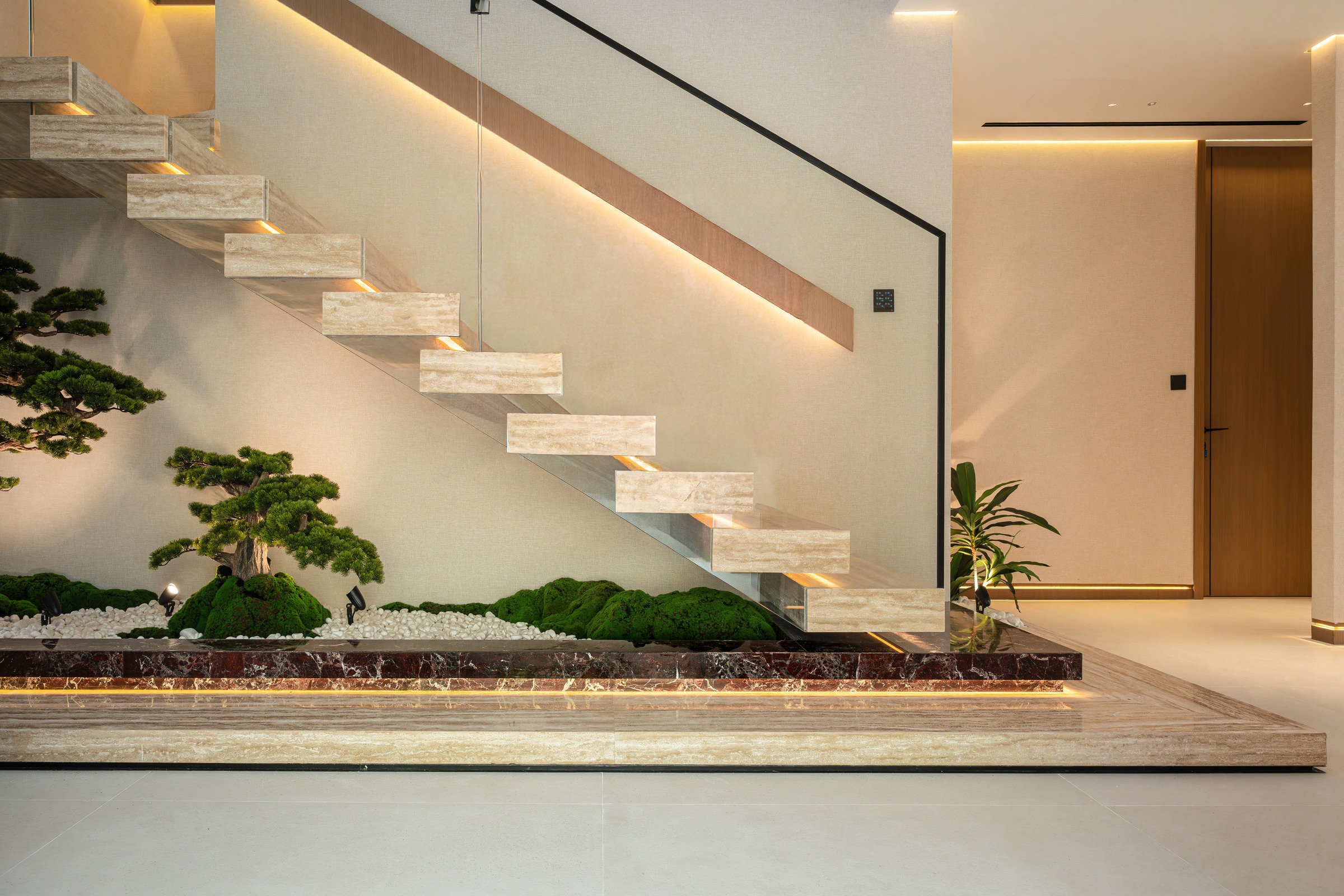 Book-matched marble staircase in a villa by Elevate Fit-Out